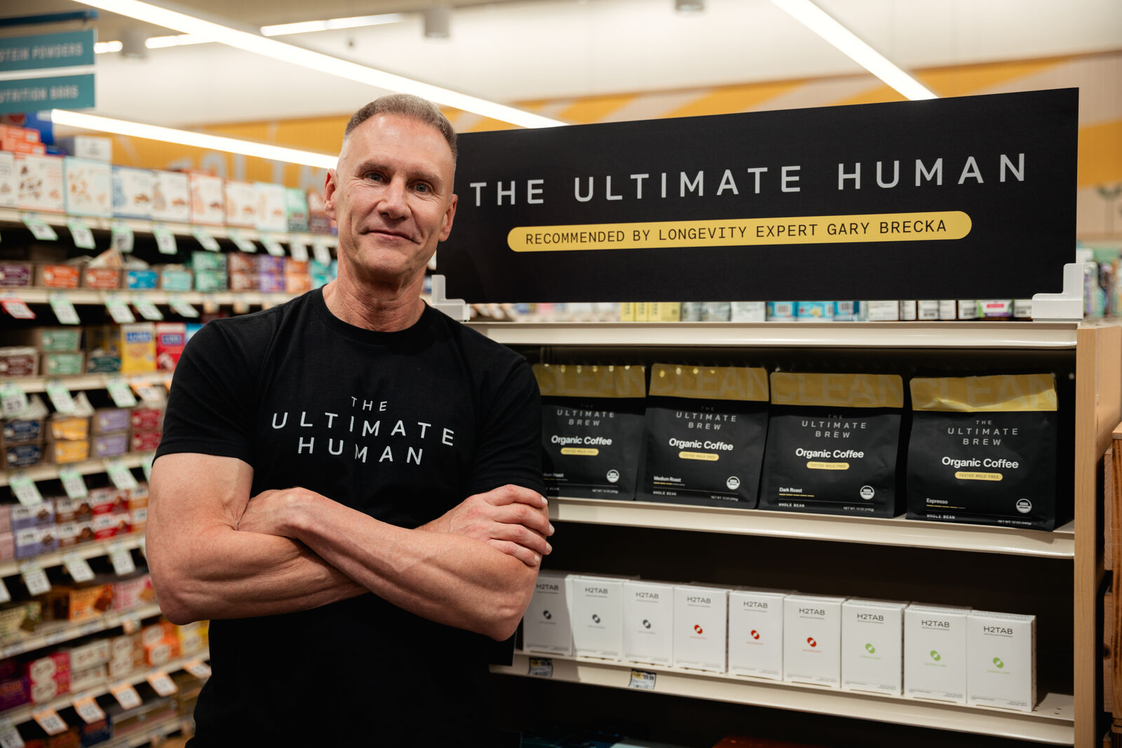 Gary Brecka at The Ultimate Human endcap in Sprouts, with The Ultimate Brew on the top shelf