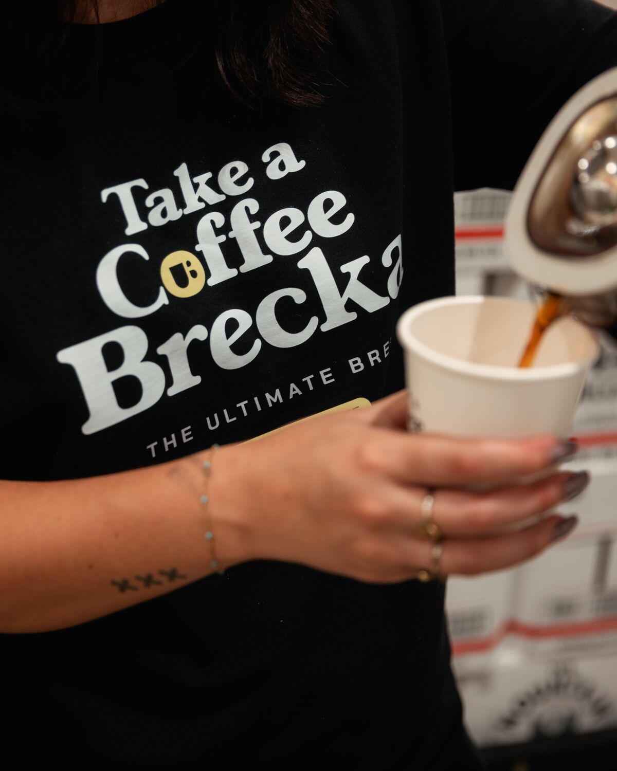 Coffee being poured into a Take a Coffee Brecka cup